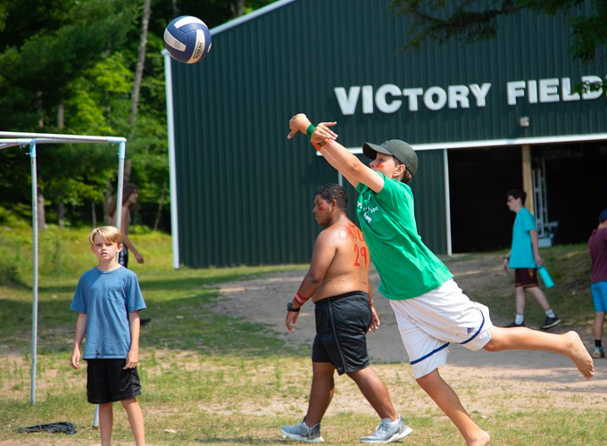 A camper at North Star Camp for Boys jumps in preparation to hit a volleyball.