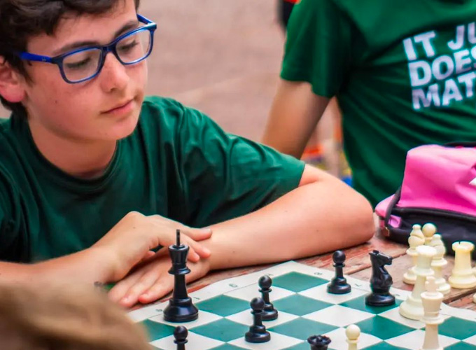 Camper focuses on determining his next move during a game of chess at North Star Camp for Boys.