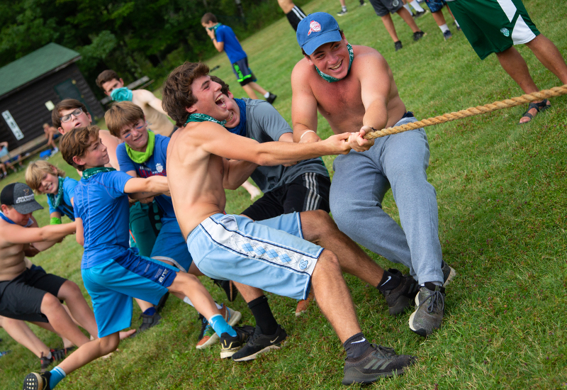 A group of campers at North Star Camp for Boys compete in a game of tug-of-war.