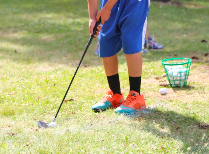 A camper practices hitting golf balls at North Star Camp for Boys.