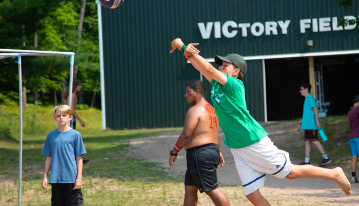 A camper at North Star Camp for Boys jumps in preparation to hit a volleyball.