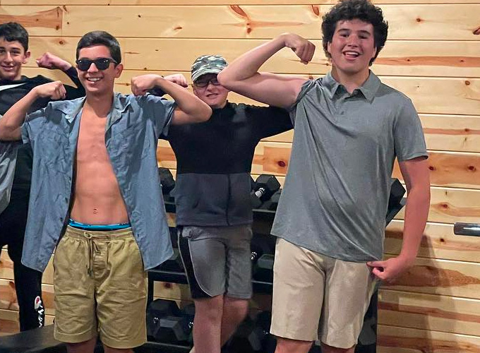 Campers show off their arm muscles at the gym at North Star Camp for Boys.