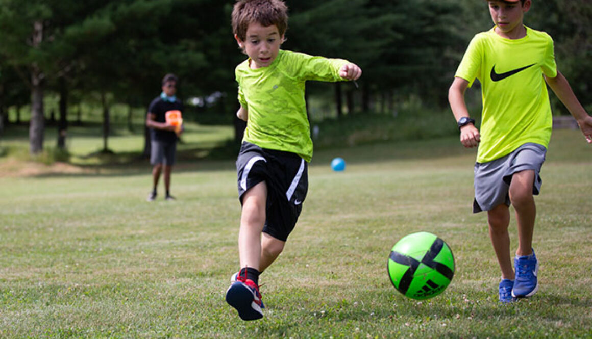 Two campers run in an attempt to intercept a soccer ball at North Star Camp for Boys.