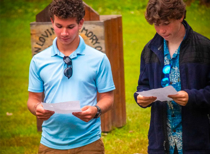 Two campers at North Star Camp for Boys read a speech from a piece of paper.