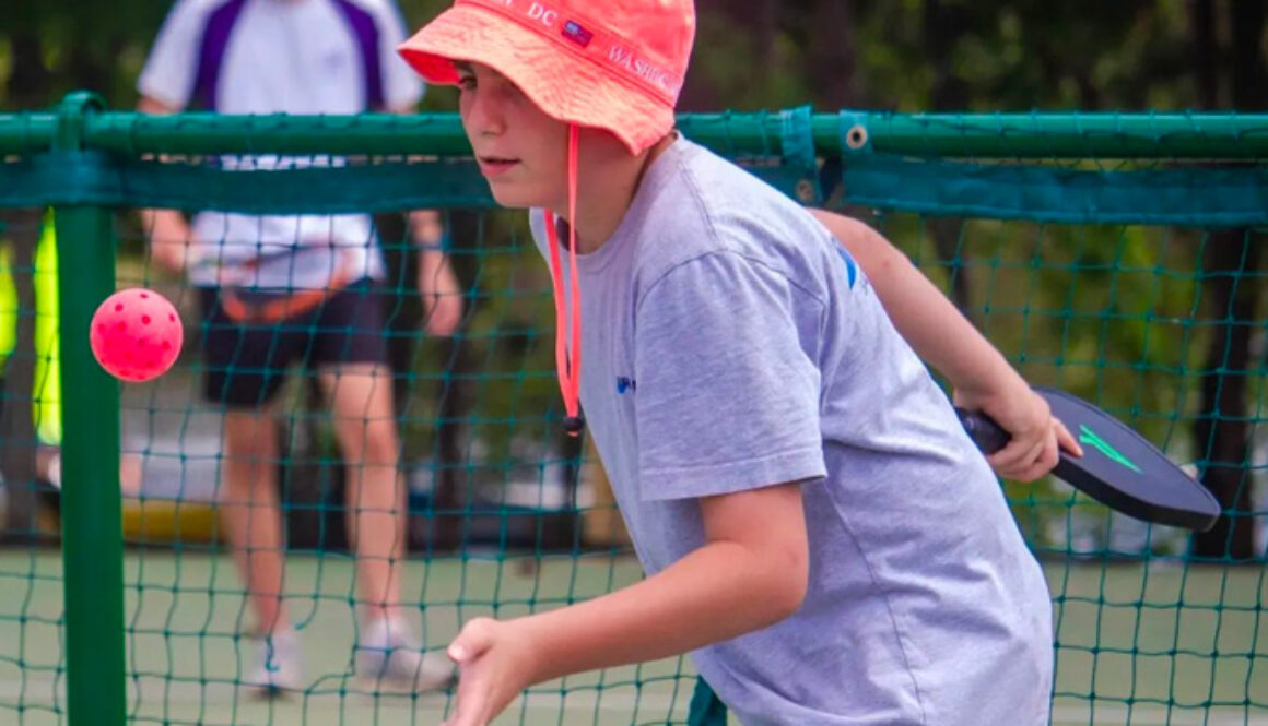 A camper prepares to hit a wiffel ball during a game of pickleball at North Star Camp for Boys.