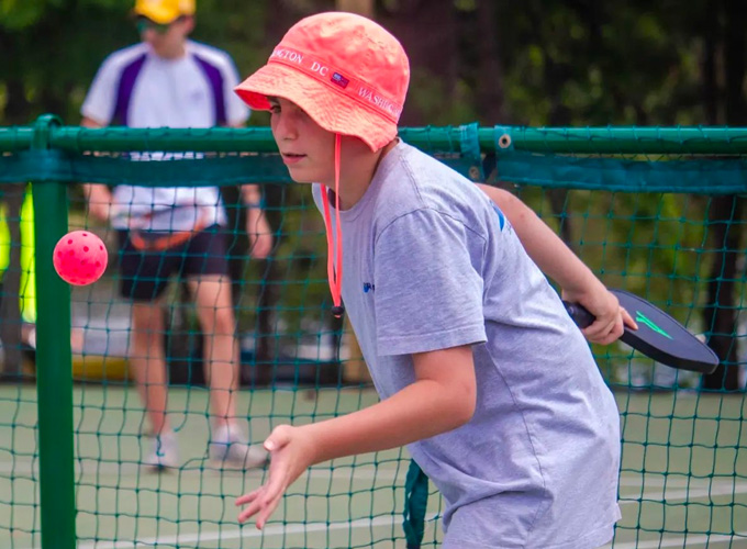 A camper prepares to hit a wiffel ball during a game of pickleball at North Star Camp for Boys.