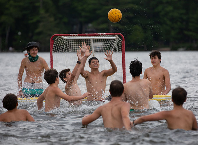 North Star Camp for Boys campers watch as the ball flies toward the goalkeeper during a game of water polo in Spider Lake.