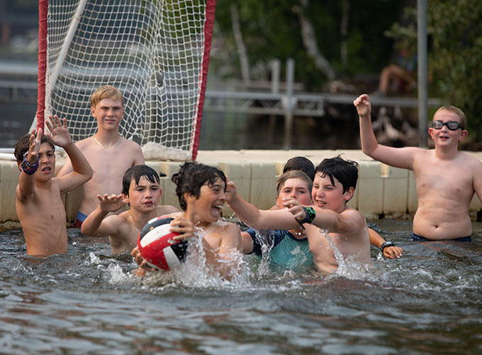 Campers try to block their opponents from throwing the ball into their net while splashing in Spider Lake at North Star Camp for Boys.