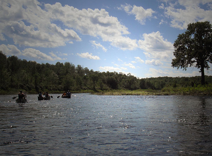 North Star Camp for Boys campers navigate the river in canoes during a wilderness trip.