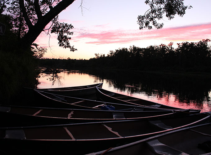 Canoes in the lake at sunset during a North Star Camp for Boys wilderness trip.