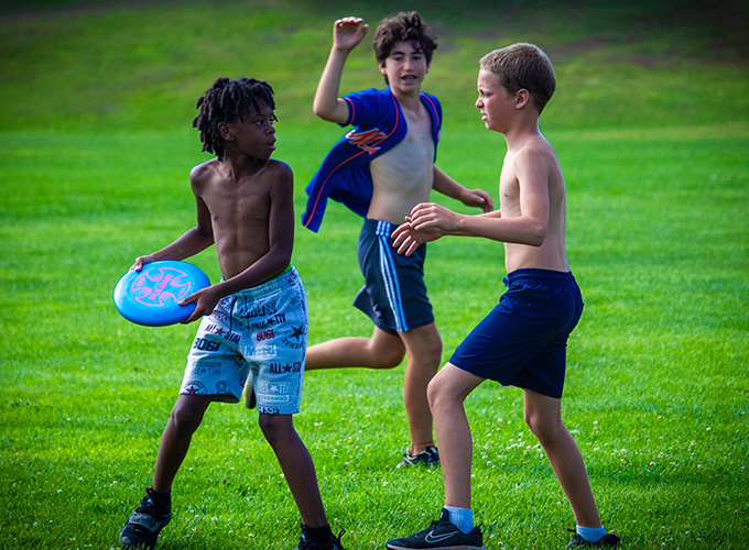 North Star Camp for Boys campers playing a competitive game of Ultimate Frisbee.
