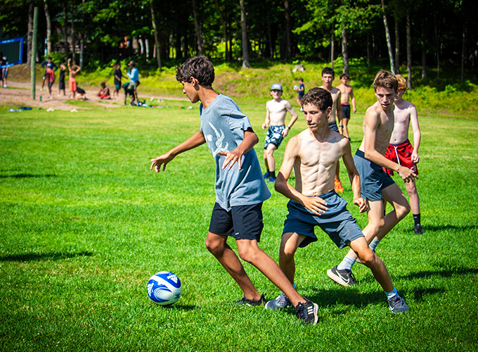 A group of campers at North Star Camp for Boys play a game of soccer while participating in college days competition.
