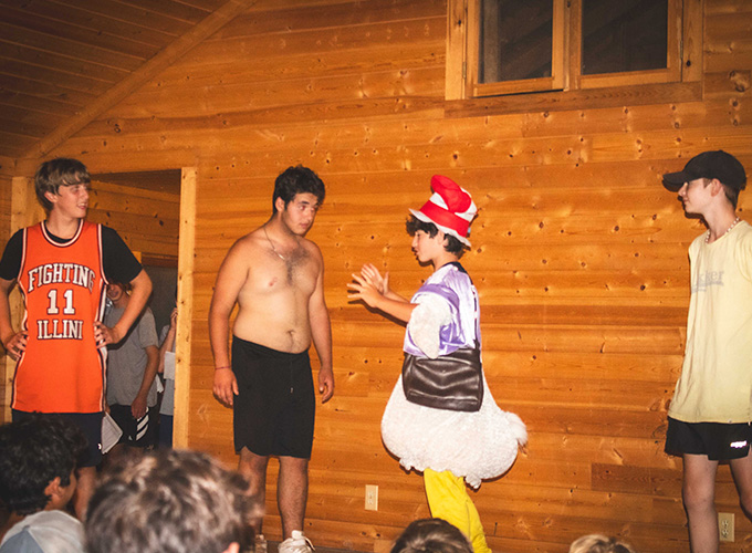 A boy wearing a duck costume stands on stage talking to his co-star while acting in a theater play at North Star Camp for Boys.