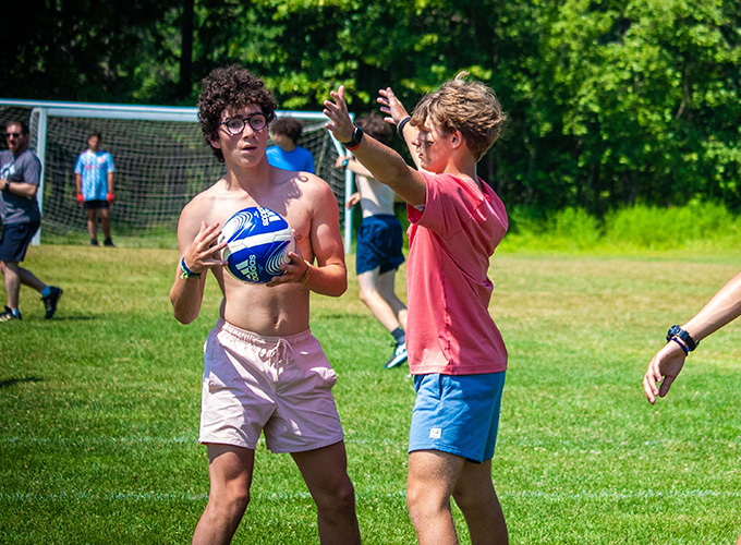 A camper attempts to block his opponent from throwing the ball during a game of speedball at North Star Camp for Boys.