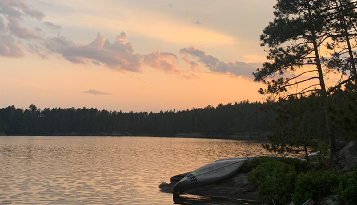 The sun setting over the lake in Quetico Provincial Park in Ontario, Canada during "The Canadian" wilderness trip at North Star Camp for Boys.