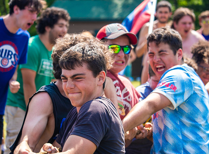 A group of campers work hard to pull the rope during an intense game of tug of war at North Star Camp for Boys.