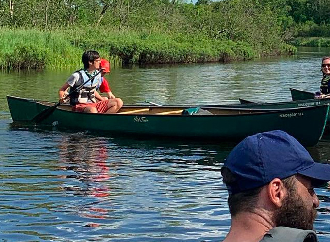 A camper paddles in a canoe through the Namekagon River during a North Star Camp for Boys wilderness trip.