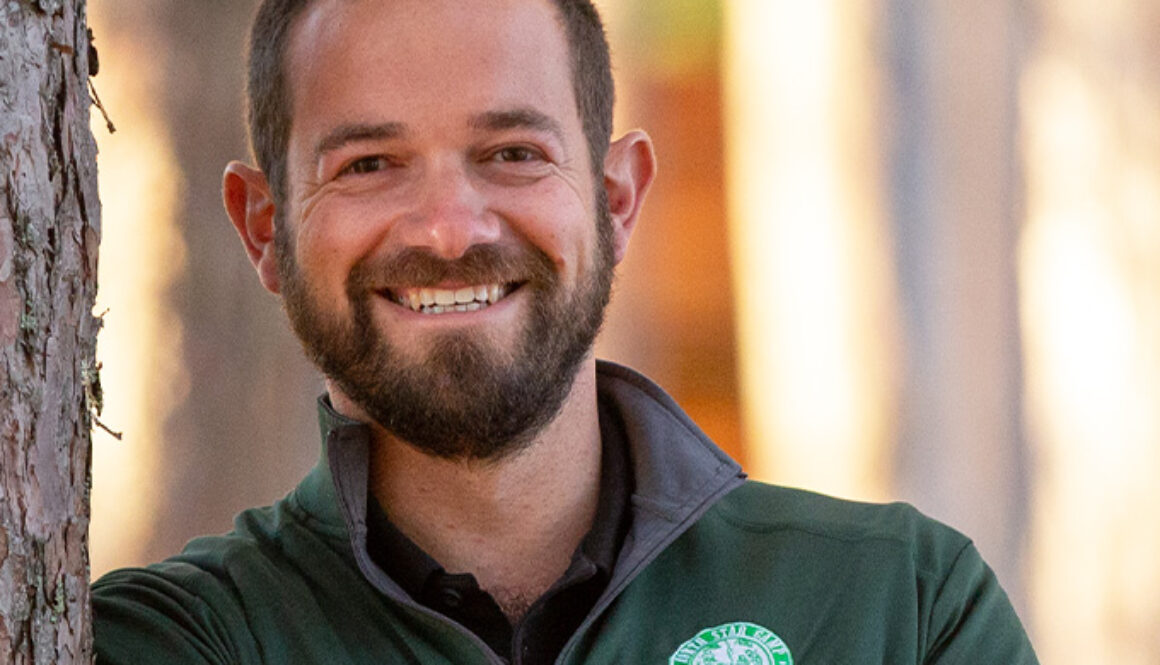 Owner and Director, Andy Shlensky, smiles for a headshot photo.