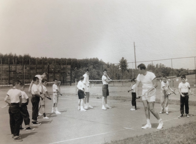 Group of campers receiving tennis instruction at North Star Camp in 1957.