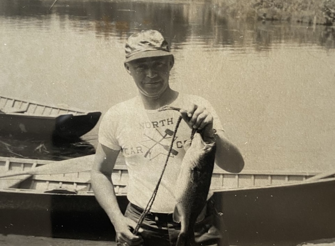 A North Star Camp counselor catches a fish on Spider Lake in 1948.