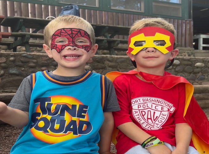Two boys dress as superheroes during Family Camp at North Star Camp for Boys.