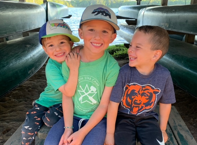 Three boys smile and have fun at Family Camp at North Star Camp For Boys.