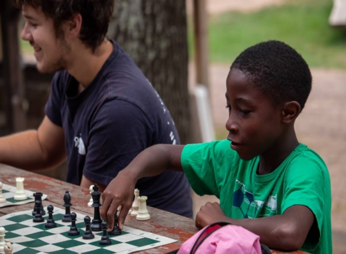 A camper at North Star Camp plays a strategic game of chess.