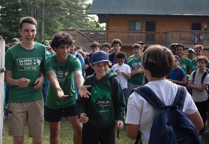 A camper meets his new cabinmates and counselors on the first day of camp at North Star Camp For Boys.