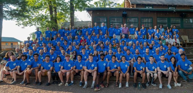 A group of North Star Camp alumni gather for the 80th Reunion at camp in 2024.