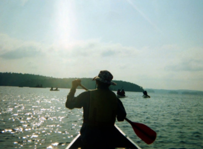 A North Star Camp camper canoes while on a wilderness camping trip in Canada.