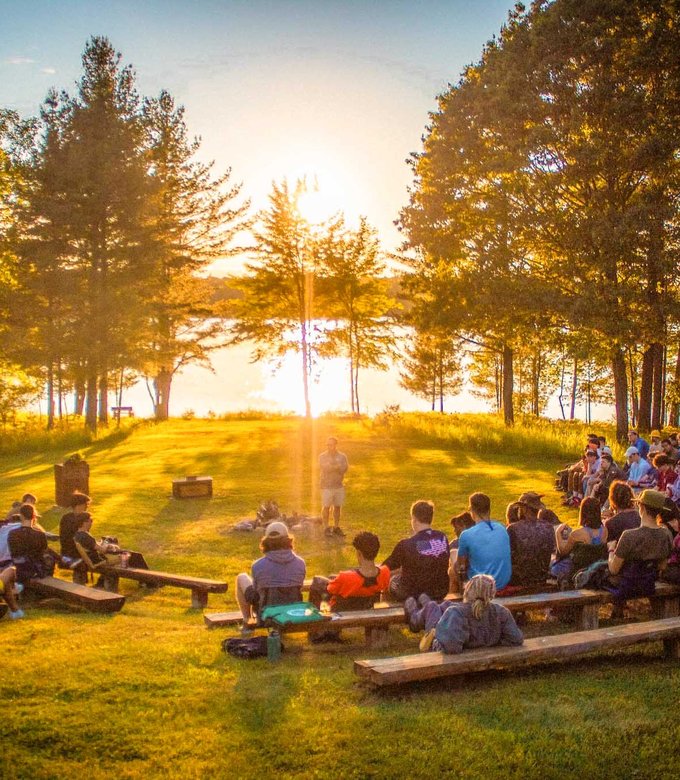 Campers gather at the council ring for Friday night services at sunset.