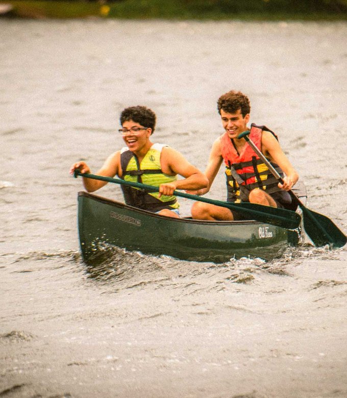 Campers paddle a canoe together on Spider Lake at North Star Camp for Boys.