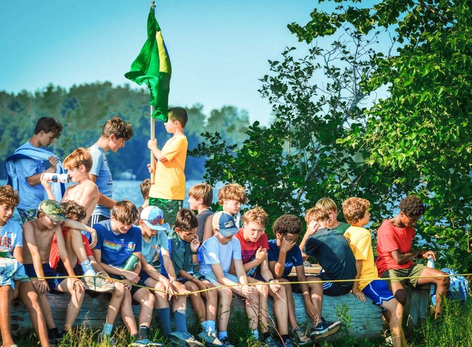 Campers watch the flag go up during the Green and White ceremony.