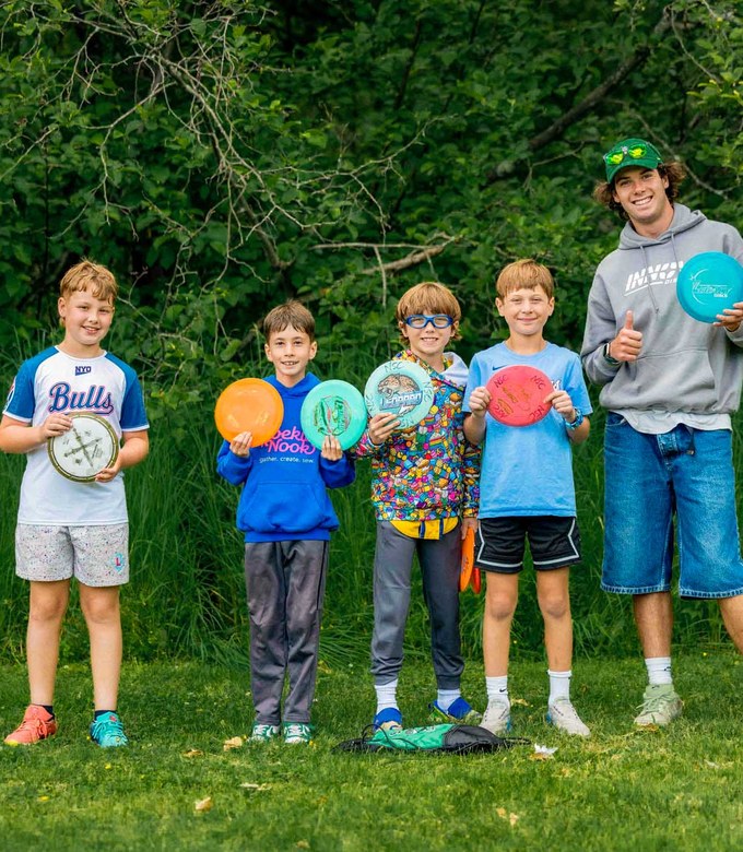 Campers hold their discs before a game of ultimate frisbee.