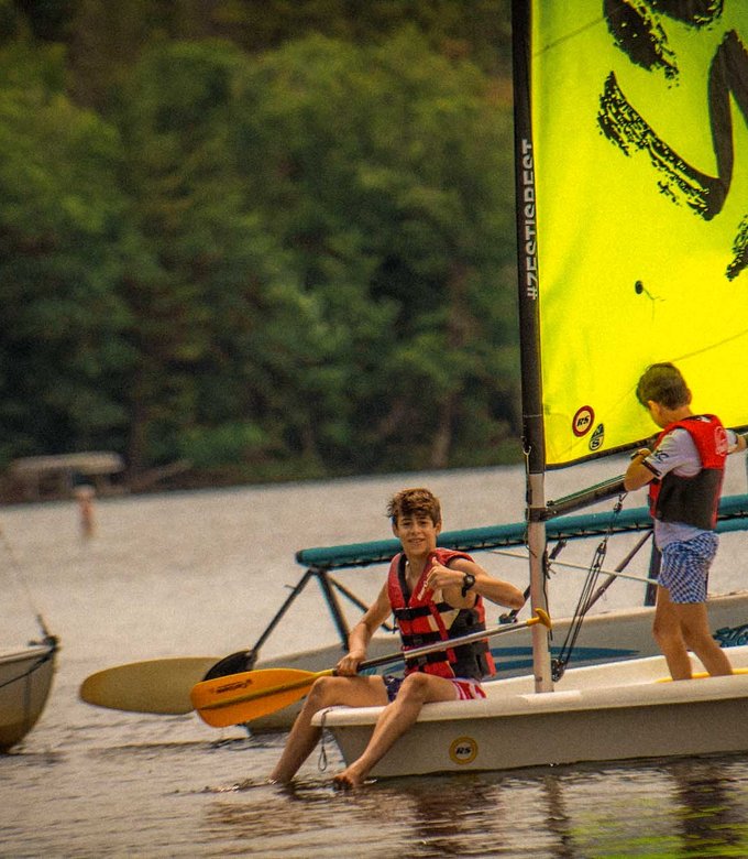 Campers rig a sailboat at the North Star Camp waterfront on Spider Lake.