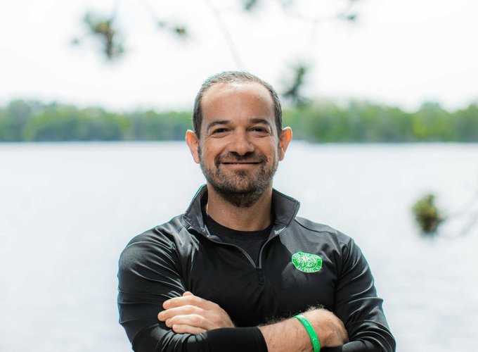 Owner and Director, Andy Shlensky, smiles for a headshot photo.